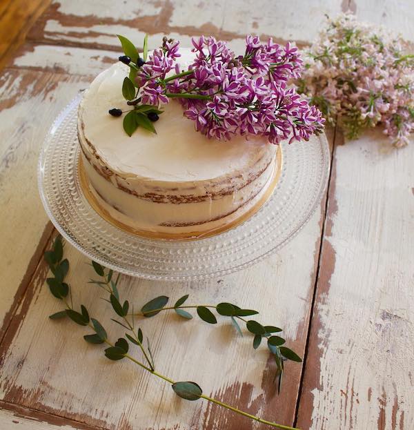 round white sheet cake decorated with purple flowers