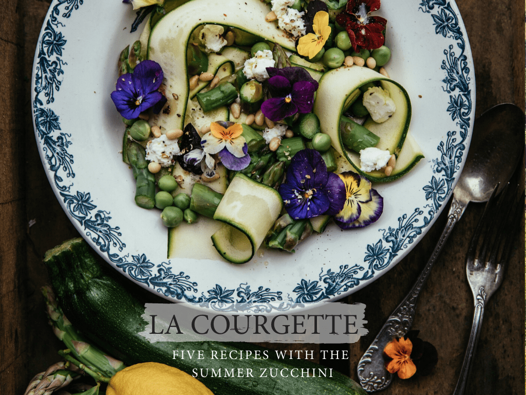 a plate of zucchini salad with edible flowers