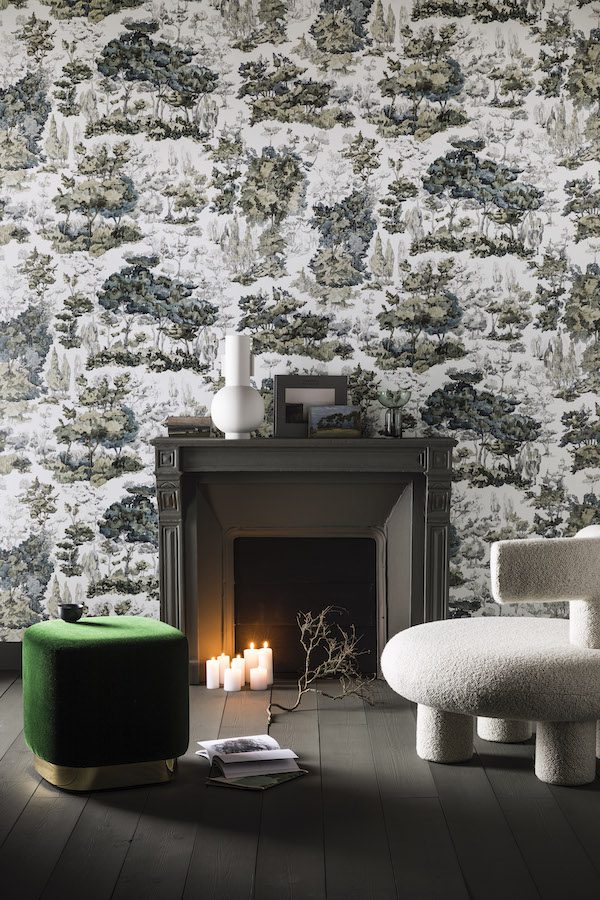 fireplace, green pouf, white chair and toile de jouy wallpaper