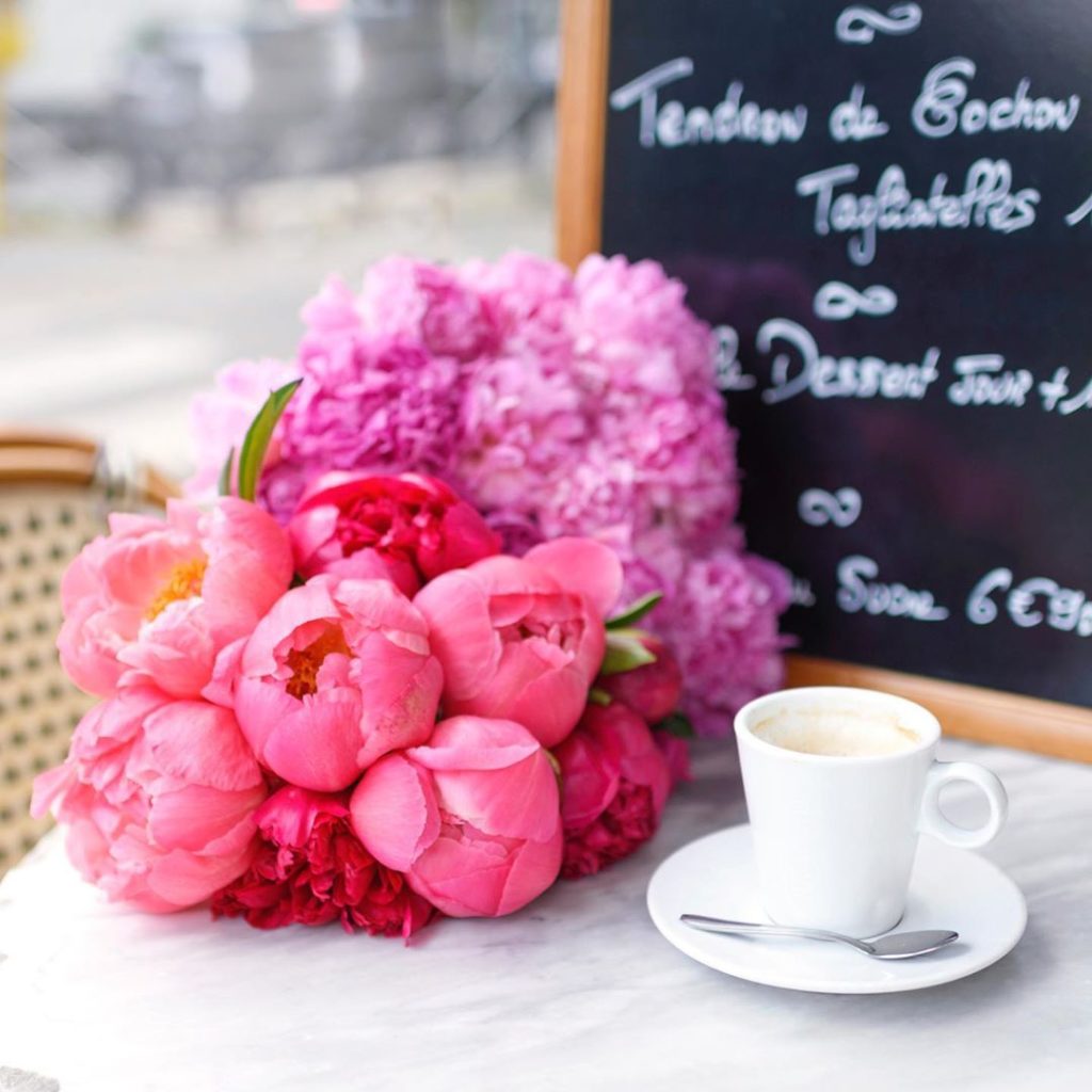 a bunch of peonies next to an espresso