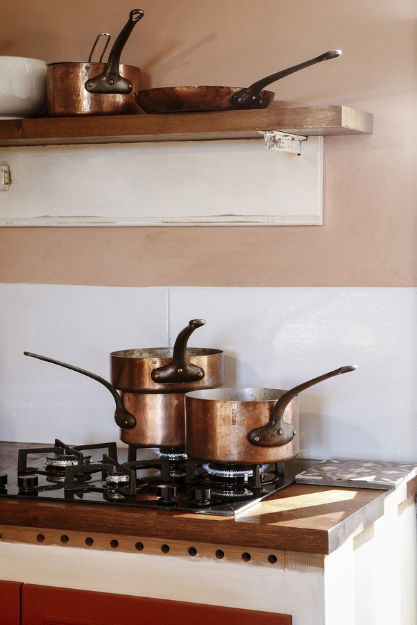 copper pots on gas stove -  French Kitchen Design Inspiration