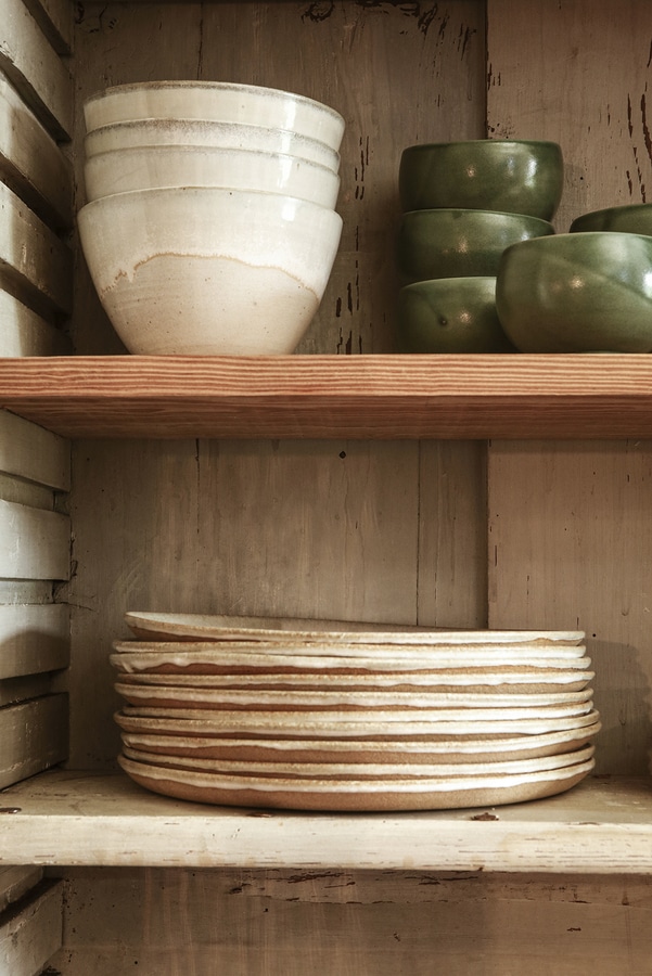 Ceramic plates stacked on shelves-  French Kitchen Design Inspiration