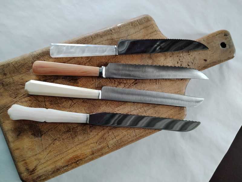 Wooden cutting board with antique bread knives