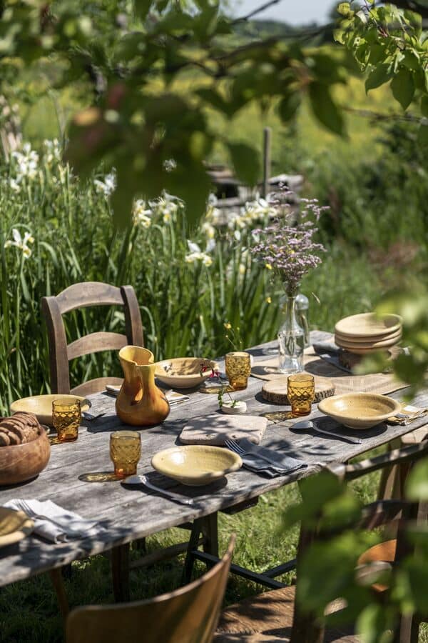 Table set up in garden with lyellow plates - Spring Tablescape